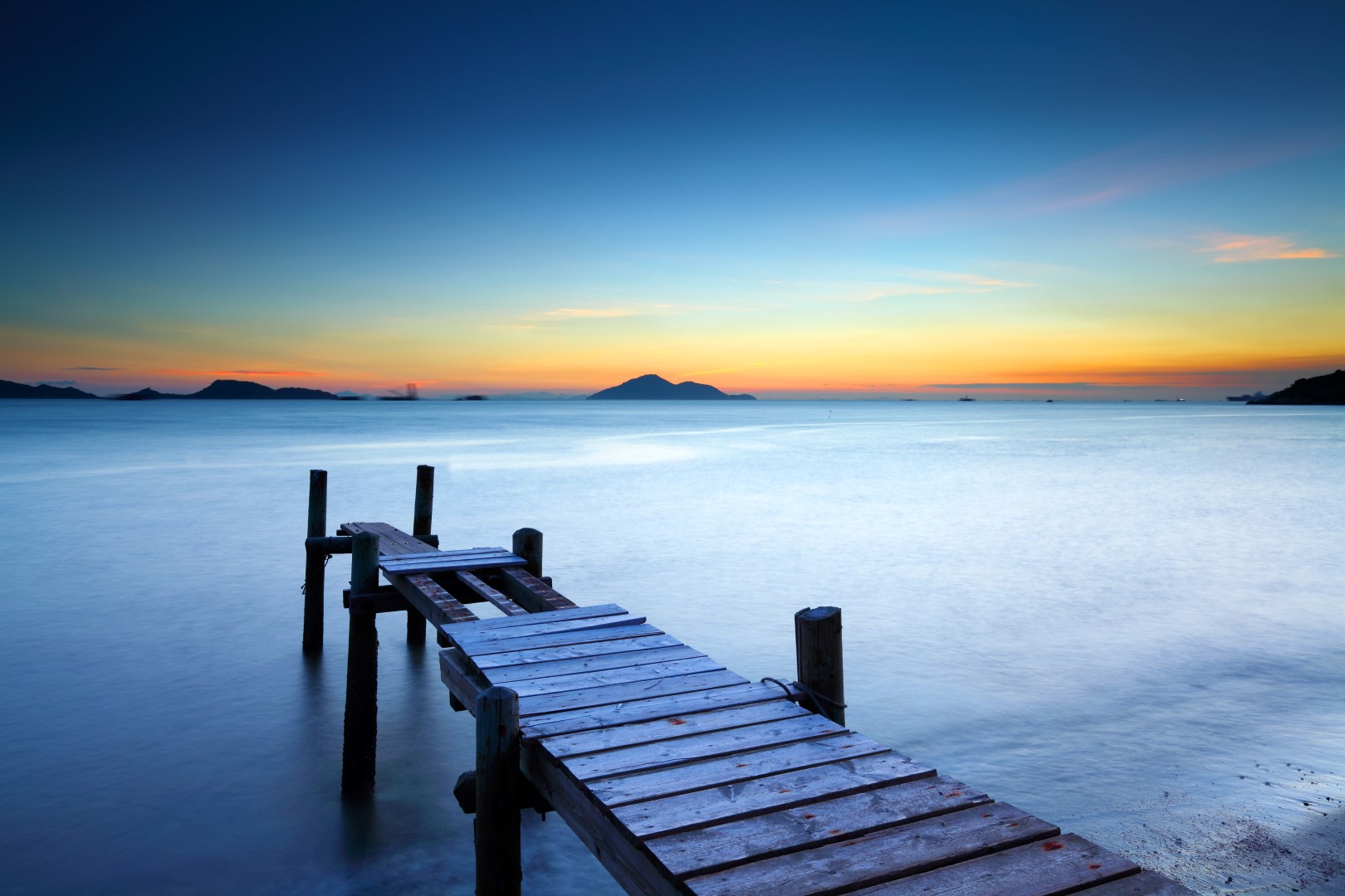 Wooden jetty with sunset